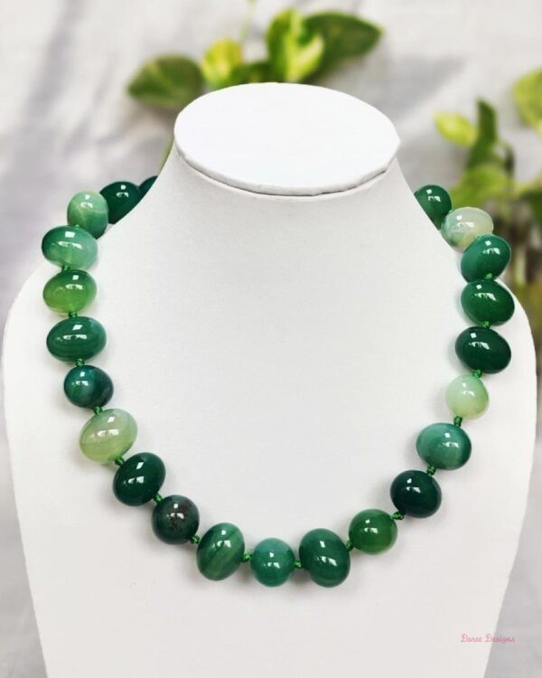 Translucent shades of ovoid-shaped sea green coloured Onyx tumbles come together in this knotted 19” single strand necklace, with a strong spring-ring clasp for durability. DN 0001