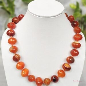 Translucent shades of ovoid-shaped toffee orange and burnt sienna coloured Onyx tumbles come together in this knotted 19” single strand necklace, with a strong spring-ring clasp for durability. DN 0002