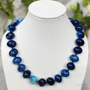 Translucent shades of ovoid-shaped deep sea blue coloured Onyx tumbles come together in this knotted 19” single strand necklace, with a strong spring-ring clasp for durability DN 0004