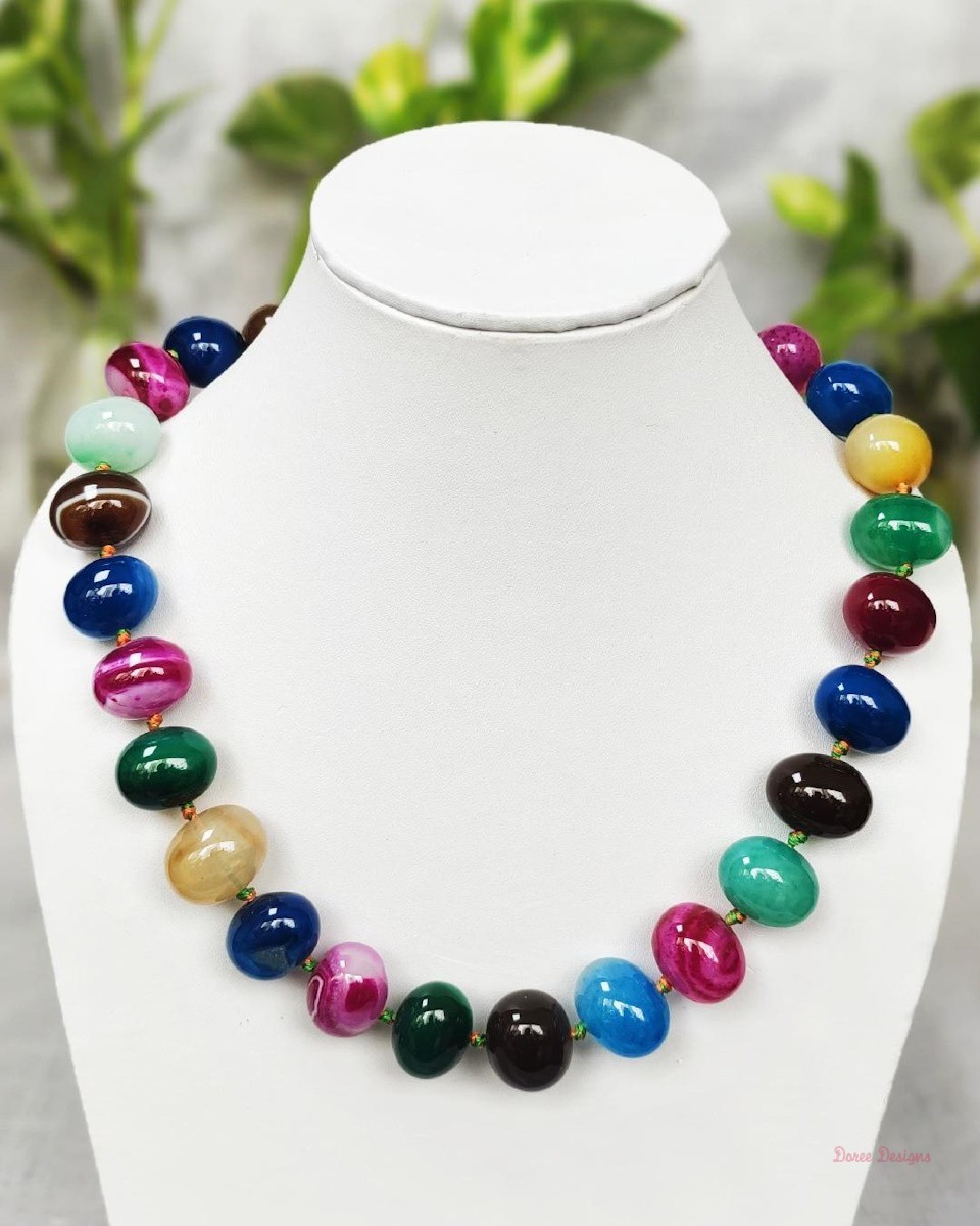 A striking mélange of ovoid-shaped bright tutti-fruiti coloured Onyx tumbles come together in this knotted 19” single strand necklace, with a strong spring-ring clasp for durability DN 0007