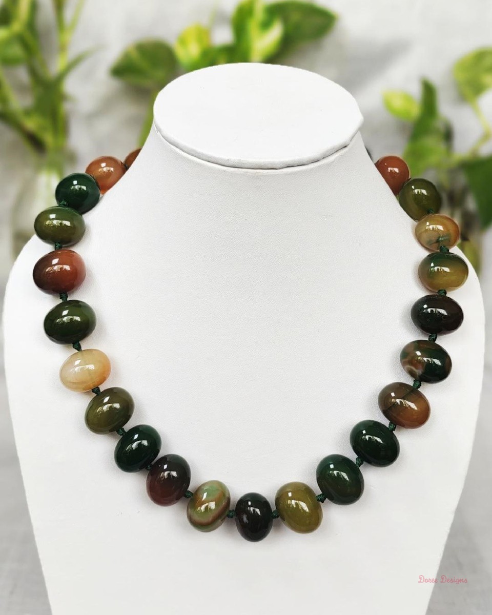 Deep and dark shades of ovoid-shaped mossy green and mud brown coloured Onyx tumbles come together in this knotted 19” single strand necklace, with a strong spring-ring clasp for durability DN 0008