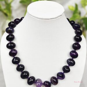 Deep and dark shades of ovoid-shaped deep indigo coloured Onyx tumbles come together in this knotted 19” single strand necklace, with a strong spring-ring clasp for durability. DN0010