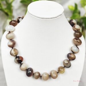 Delightful shades of ovoid-shaped white and brown chocolate coloured swirls of Onyx tumbles come together in this knotted 19” single strand necklace, with a strong spring-ring clasp for durability. DN0011