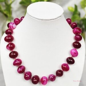 Delightfully dark shades of ovoid-shaped shocking magenta-pink coloured Onyx tumbles come together in this knotted 19” single strand necklace, with a strong spring-ring clasp for durability. DN0012