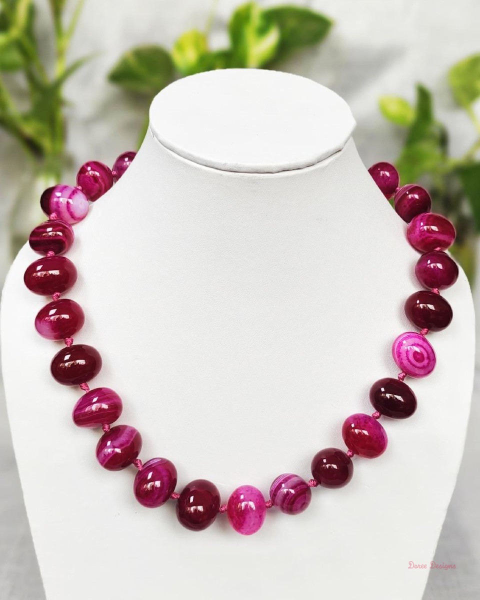 Delightfully dark shades of ovoid-shaped shocking magenta-pink coloured Onyx tumbles come together in this knotted 19” single strand necklace, with a strong spring-ring clasp for durability. DN0012