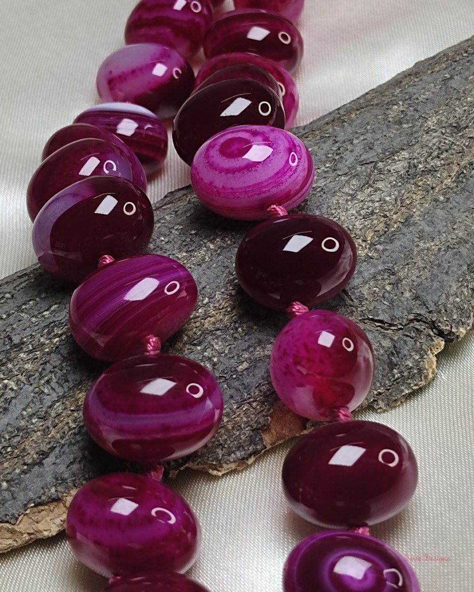 Delightfully dark shades of ovoid-shaped shocking magenta-pink coloured Onyx tumbles come together in this knotted 19” single strand necklace, with a strong spring-ring clasp for durability. DN0012