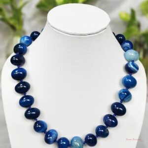 Translucent shades of ovoid-shaped deep sea blue coloured Onyx tumbles come together in this knotted 19” single strand necklace, with a strong spring-ring clasp for durability. DN0016