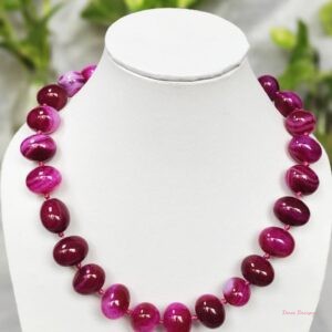 Delightfully dark shades of ovoid-shaped shocking magenta-pink coloured Onyx tumbles come together in this knotted 19” single strand necklace, with a strong spring-ring clasp for durability. DN0017