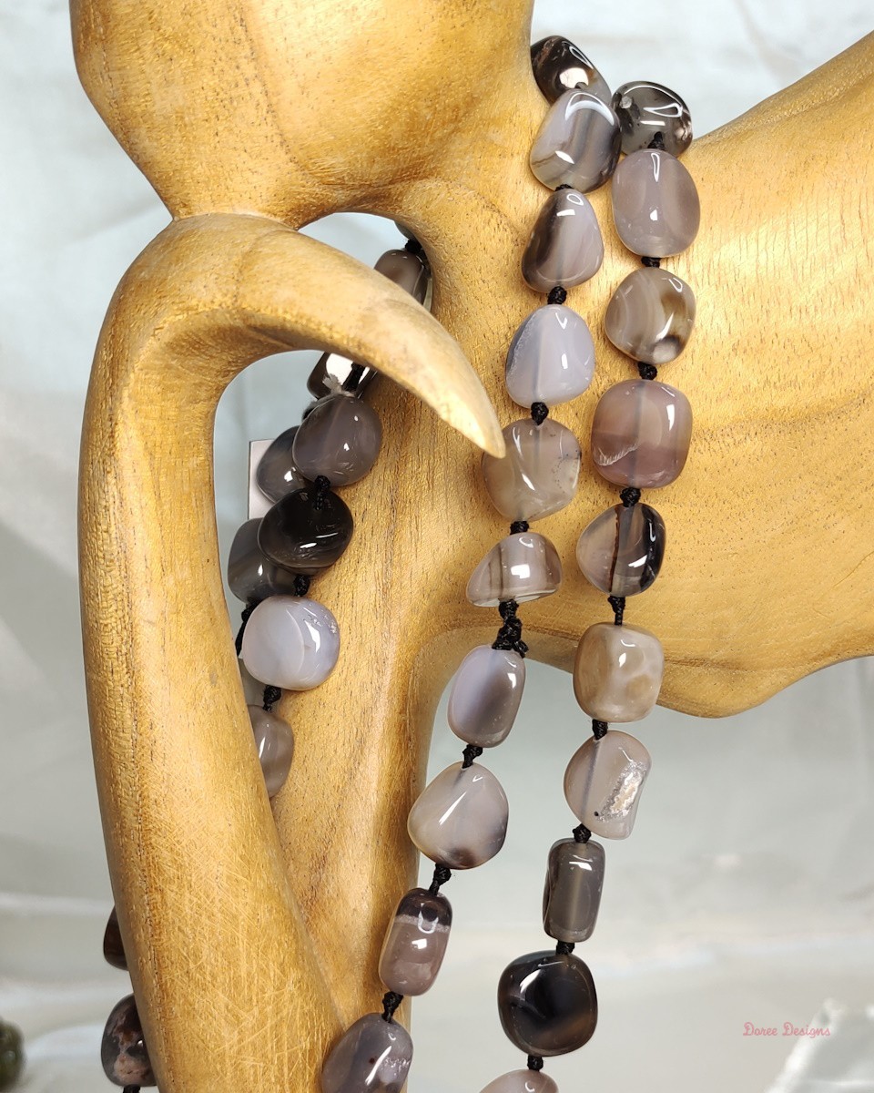 Desert Princess -Delightful irregular tumbles of Onyx in shades of chocolate browns mottled in white and black come together in this knotted 36” single strand necklace. DN0022