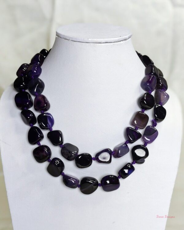 Royal Touch - Delightful irregular tumbles of Onyx in shades of deep royal purple with flecks of white come together in this knotted 36” single strand necklace. DN0023