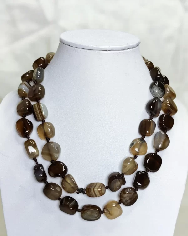 Brown Sugar - Delightful irregular tumbles of Onyx in all the shades of chocolate brown and mottled with white come together in this knotted 36” single strand necklace. DN0026