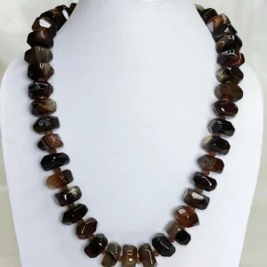 Browning Glory - Double cushion cut beads of Onyx in all shades of sandy and bark brown flecked with varying shades of white come together in this knotted 18” single strand necklace. DN0033