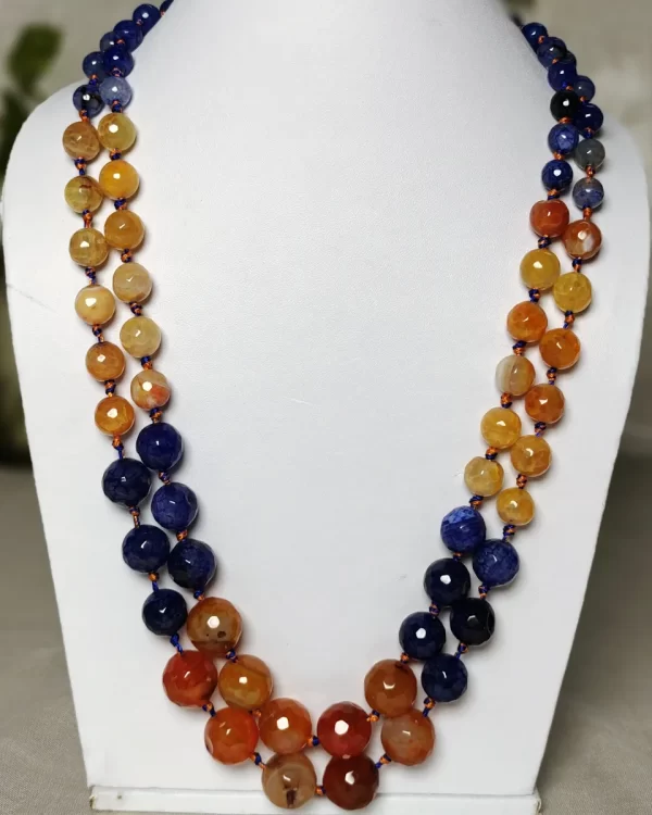 Hippie Chic - Knotted 18” double strand of Onyx beads graded by size, in a palette featuring a mélange of blues and oranges of all shades – with banding, splotching, and marbling patterns. DN0042