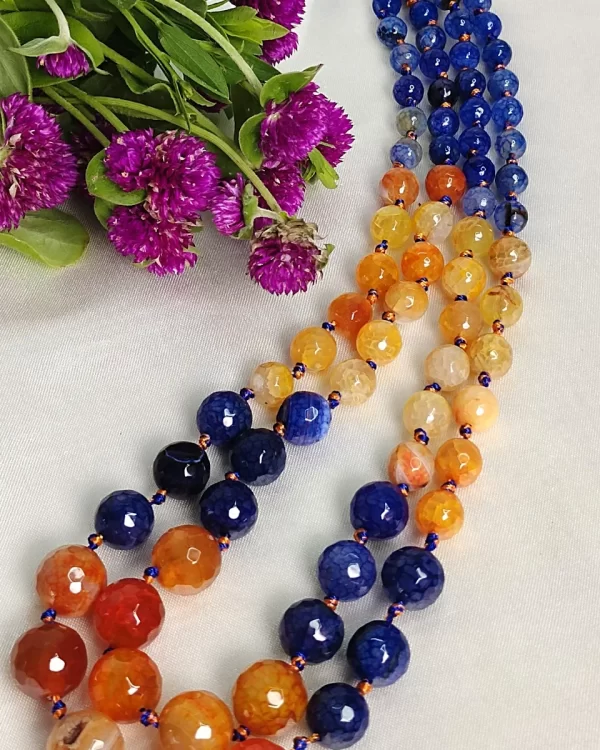 Hippie Chic - Knotted 18” double strand of Onyx beads graded by size, in a palette featuring a mélange of blues and oranges of all shades – with banding, splotching, and marbling patterns. DN0042