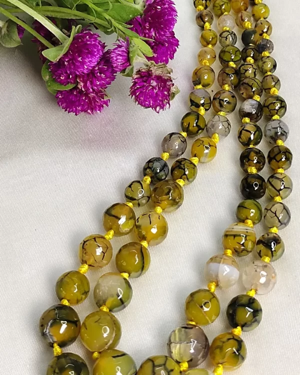 Melon Summer - Knotted 18” double strand of Onyx beads graded by size, in a palette featuring a mélange of melon, silver, and mustard yellows of all shades with banding, splotching, and marbling patterns, and griddled with dragon veins. DN0043