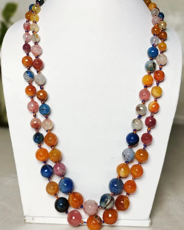 Summer Burst - Knotted 18” double strand of Onyx beads graded by size, in a palette featuring a mélange of oranges, blues, browns, pinks, and off white shades with banding, splotching, and marbling patterns, and griddled with dragon veins. DN0045