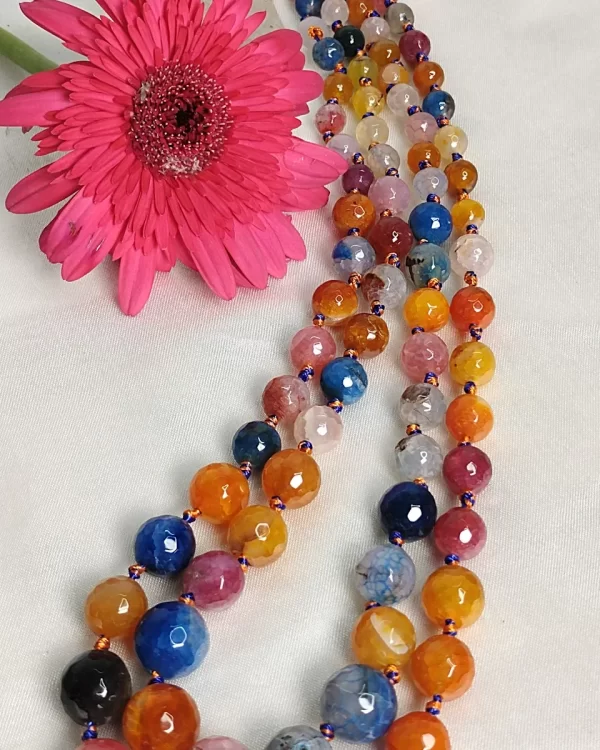 Summer Burst - Knotted 18” double strand of Onyx beads graded by size, in a palette featuring a mélange of oranges, blues, browns, pinks, and off white shades with banding, splotching, and marbling patterns, and griddled with dragon veins. DN0045