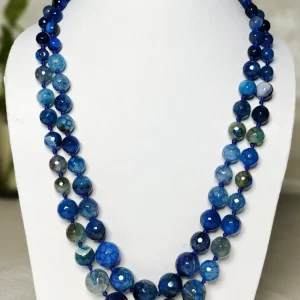 Blue Riband - Knotted 18” double strand of Onyx beads graded by size, in a palette featuring a mélange of fresh sky and electric blues with banding, splotching, and marbling patterns, and griddled with dragon veins. DN0046