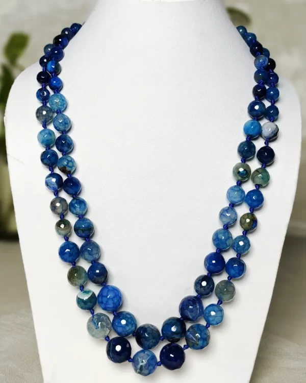 Blue Riband - Knotted 18” double strand of Onyx beads graded by size, in a palette featuring a mélange of fresh sky and electric blues with banding, splotching, and marbling patterns, and griddled with dragon veins. DN0046