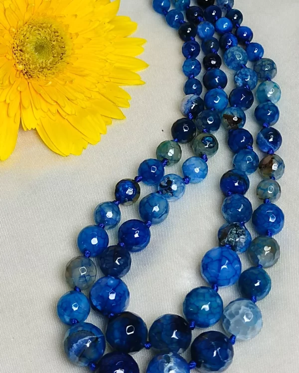 Blue Riband - Knotted 18” double strand of Onyx beads graded by size, in a palette featuring a mélange of fresh sky and electric blues with banding, splotching, and marbling patterns, and griddled with dragon veins. DN0046