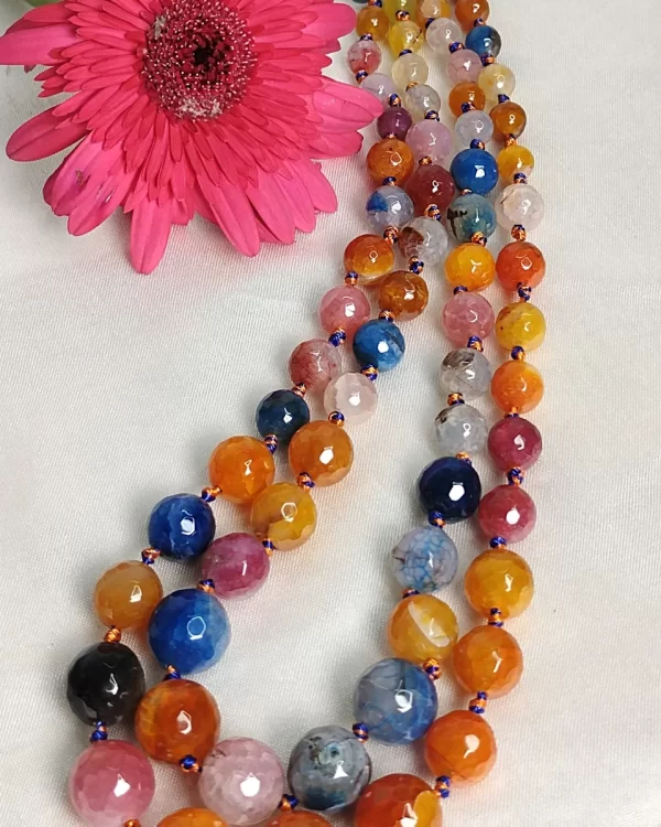 Summer Burst - Knotted 18” double strand of Onyx beads graded by size, in a palette featuring a mélange of oranges, blues, browns, pinks, and off white shades with banding, splotching, and marbling patterns, and griddled with dragon veins. DN0047