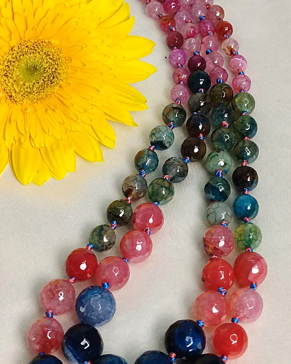 Bubble Gum - Knotted 18” double strand of Onyx beads graded by size, in a palette featuring a mélange of pinks, aqua greens, juicy reds, and sky blue shades with banding, splotching, and marbling patterns, and griddled with dragon veins. DN0048