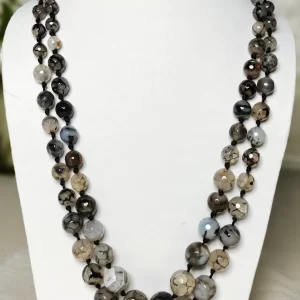 Evening Calm - Knotted 18” double strand of Onyx beads graded by size, in a palette featuring a mélange of translucent whites, blacks, grays and a dab of blue – with banding, splotching, and marbling patterns and griddled with dragon veins. DN0050