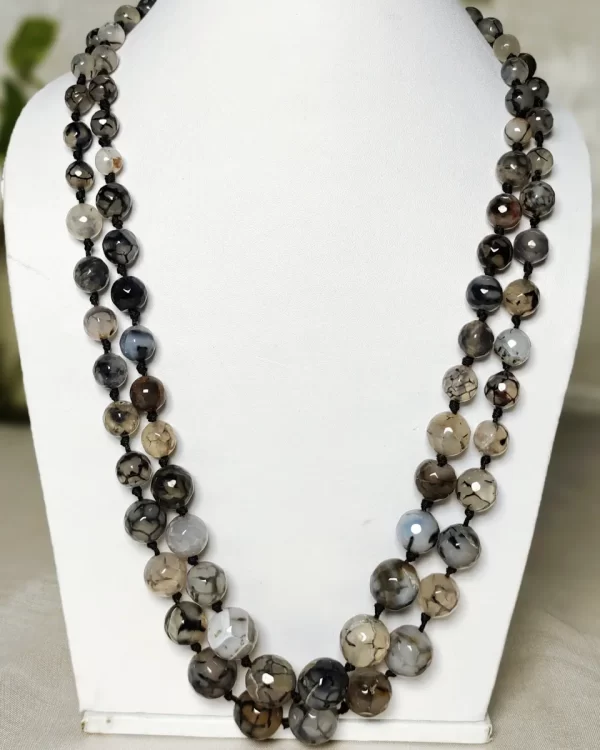 Evening Calm - Knotted 18” double strand of Onyx beads graded by size, in a palette featuring a mélange of translucent whites, blacks, grays and a dab of blue – with banding, splotching, and marbling patterns and griddled with dragon veins. DN0050