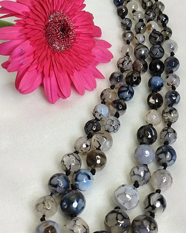 Evening Calm - Knotted 18” double strand of Onyx beads graded by size, in a palette featuring a mélange of translucent whites, blacks, grays and a dab of blue – with banding, splotching, and marbling patterns and griddled with dragon veins. DN0050