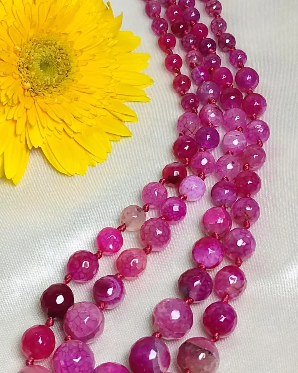 Pink Parade - Knotted 18” double strand of Onyx beads graded by size, in a palette featuring range of pink shades – with banding, splotching, and marbling patterns and griddled with dragon veins. DN0051