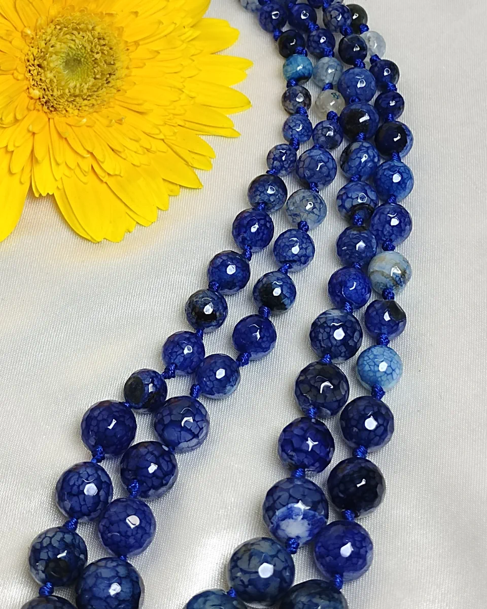 Blue Riband - Knotted 18” double strand of Onyx beads graded by size, in a palette featuring a mélange of fresh sky and electric blues with banding, splotching, and marbling patterns, and griddled with dragon veins. DN0052