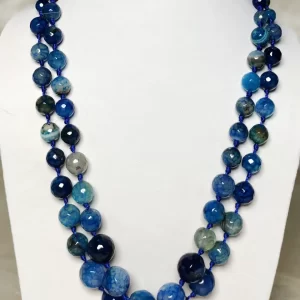 Blue Riband - Knotted 18” double strand of Onyx beads graded by size, in a palette featuring a mélange of fresh sky and electric blues with banding, splotching, and marbling patterns, and griddled with dragon veins. DN0053