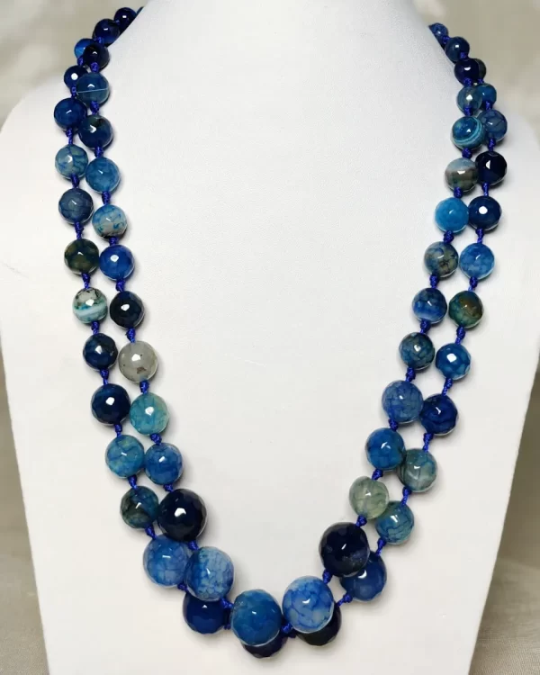 Blue Riband - Knotted 18” double strand of Onyx beads graded by size, in a palette featuring a mélange of fresh sky and electric blues with banding, splotching, and marbling patterns, and griddled with dragon veins. DN0053