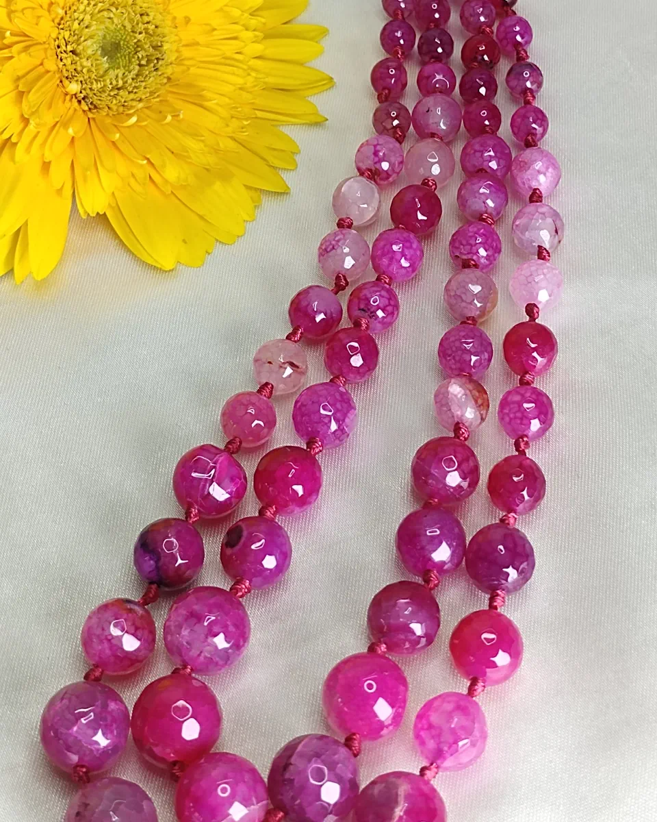 Pink Parade - Knotted 18” double strand of Onyx beads graded by size, in a palette featuring range of pink shades – with banding, splotching, and marbling patterns and griddled with dragon veins. DN0054