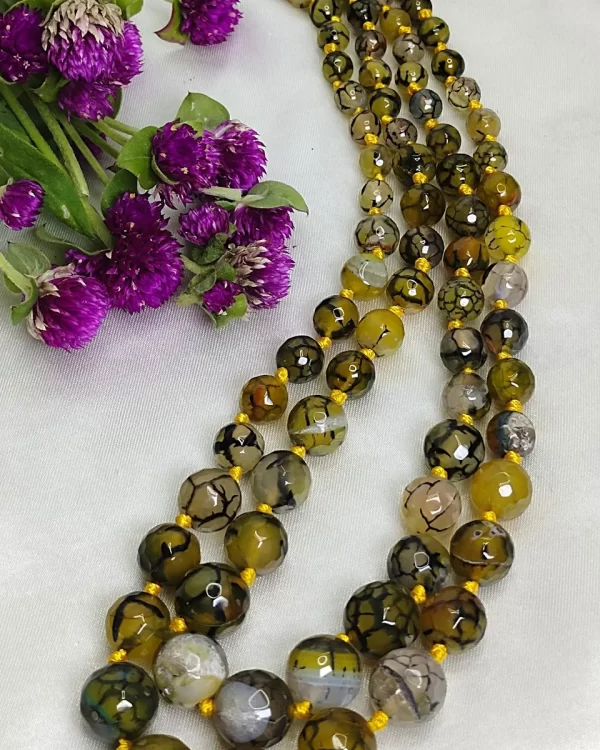 Melon Summer - Knotted 18” double strand of Onyx beads graded by size, in a palette featuring a mélange of melon, silver, and mustard yellows of all shades with banding, splotching, and marbling patterns, and griddled with dragon veins. DN0056