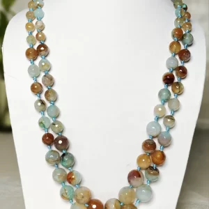 Dusty Diva - Knotted 18” double strand of Onyx beads graded by size, in a palette featuring a mélange of tropical sky blues and romantic desert brown shades with banding, splotching, and marbling patterns, and griddled with dragon veins. DN0057