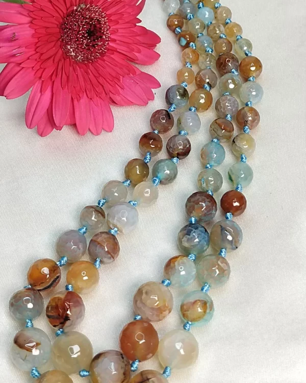 Dusty Diva - Knotted 18” double strand of Onyx beads graded by size, in a palette featuring a mélange of tropical sky blues and romantic desert brown shades with banding, splotching, and marbling patterns, and griddled with dragon veins. DN0057