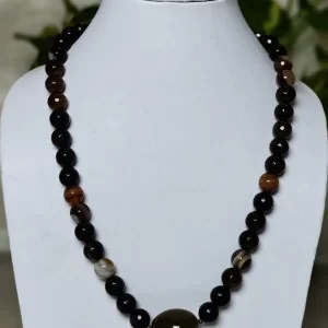 Brown Band - DN0132 - A collection of clouded and banded honey-cut beads of Onyx in all shades of brown and honey in an eye-catching 18" necklace, setting off a plain light mossy brown Agate tumble