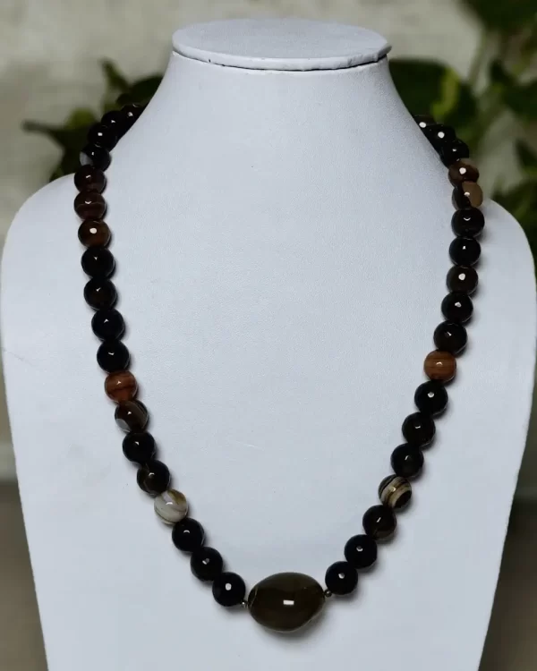 Brown Band - DN0132 - A collection of clouded and banded honey-cut beads of Onyx in all shades of brown and honey in an eye-catching 18" necklace, setting off a plain light mossy brown Agate tumble