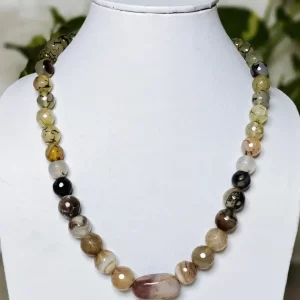 Carefree Cruise - DN0135 - A collection of clouded and banded honey-cut beads of Onyx in a variety of matching shades all arrayed around an Agate tumble as a central piece in this alluring 16" necklace