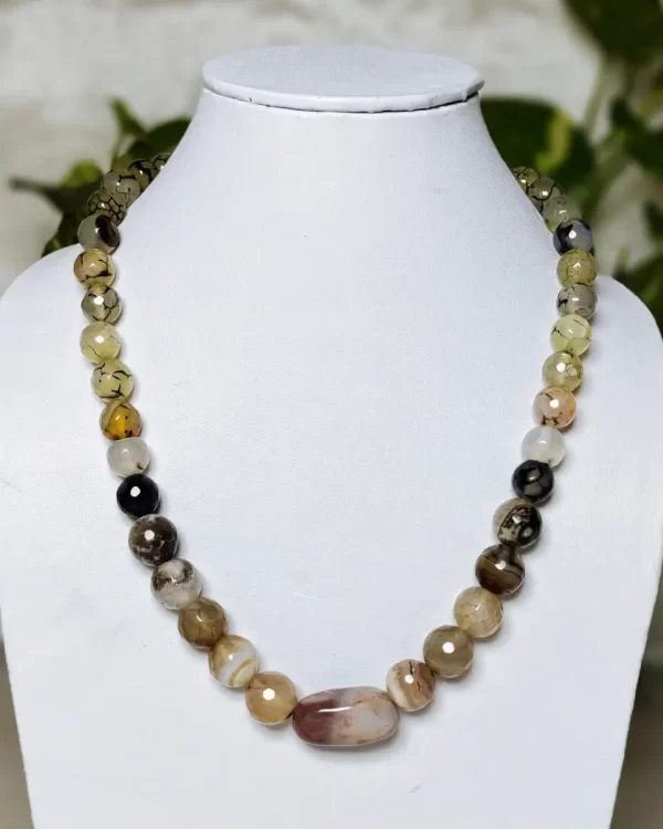 Carefree Cruise - DN0135 - A collection of clouded and banded honey-cut beads of Onyx in a variety of matching shades all arrayed around an Agate tumble as a central piece in this alluring 16" necklace