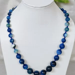 Blue Bonanza – DN0218 - Knotted 19” single strand of Onyx beads, in a wide palette of blues with banding, splotching, and marbling patterns, and griddled with dragon veins.