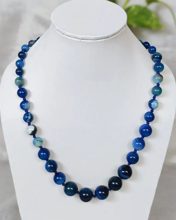 Blue Bonanza – DN0218 - Knotted 19” single strand of Onyx beads, in a wide palette of blues with banding, splotching, and marbling patterns, and griddled with dragon veins.