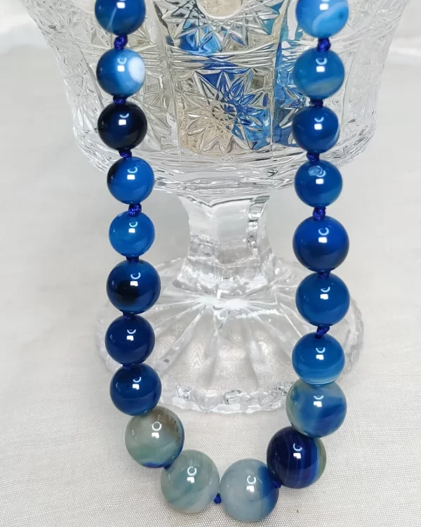 Blue Bonanza – DN0218 - Knotted 19” single strand of Onyx beads, in a wide palette of blues with banding, splotching, and marbling patterns, and griddled with dragon veins.